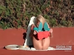 Slim Sasha working her horny cunt on the tennis field