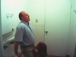Redhead secretary sucking boss's dick in a toilet