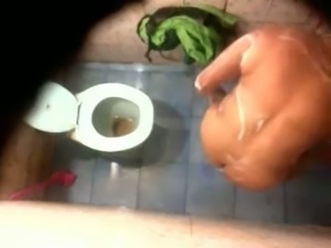 Hidden cam in the toilet room catches Indian milf wife