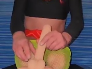 Dressed in my sexy red mini and  green fishnet pantiyh riding my dildo from...